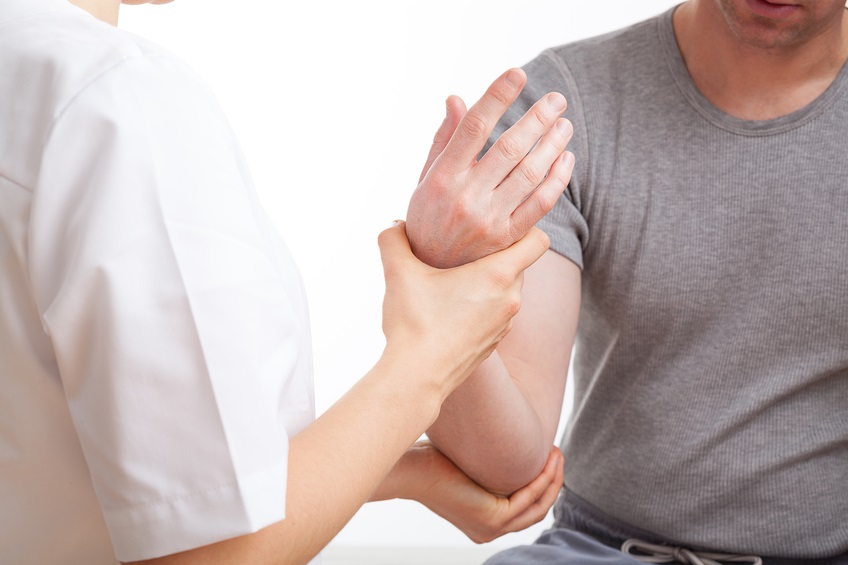 Patient with elbow ache has rehabilitation in physiotherapy clinic