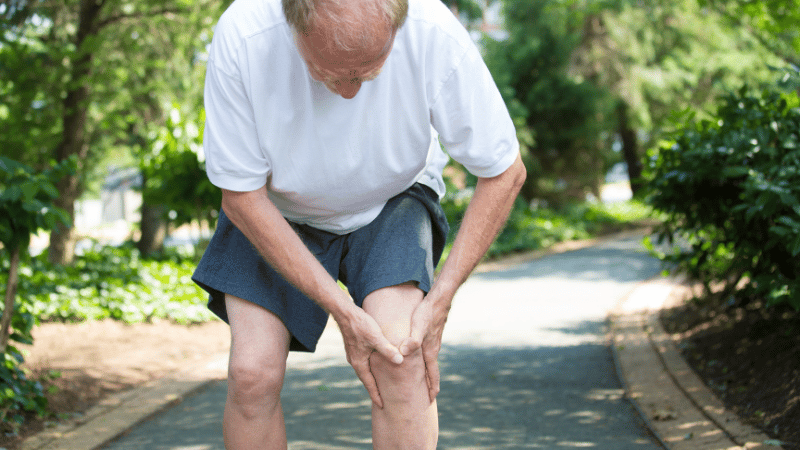 old white male walking in park with osteoarthritic knee